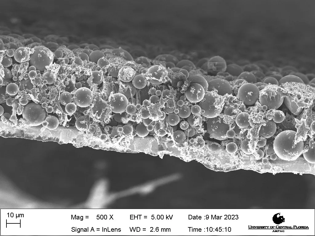 Cross-section SEM of a coated electrode showing Glassact spheres distributed in a binder matrix